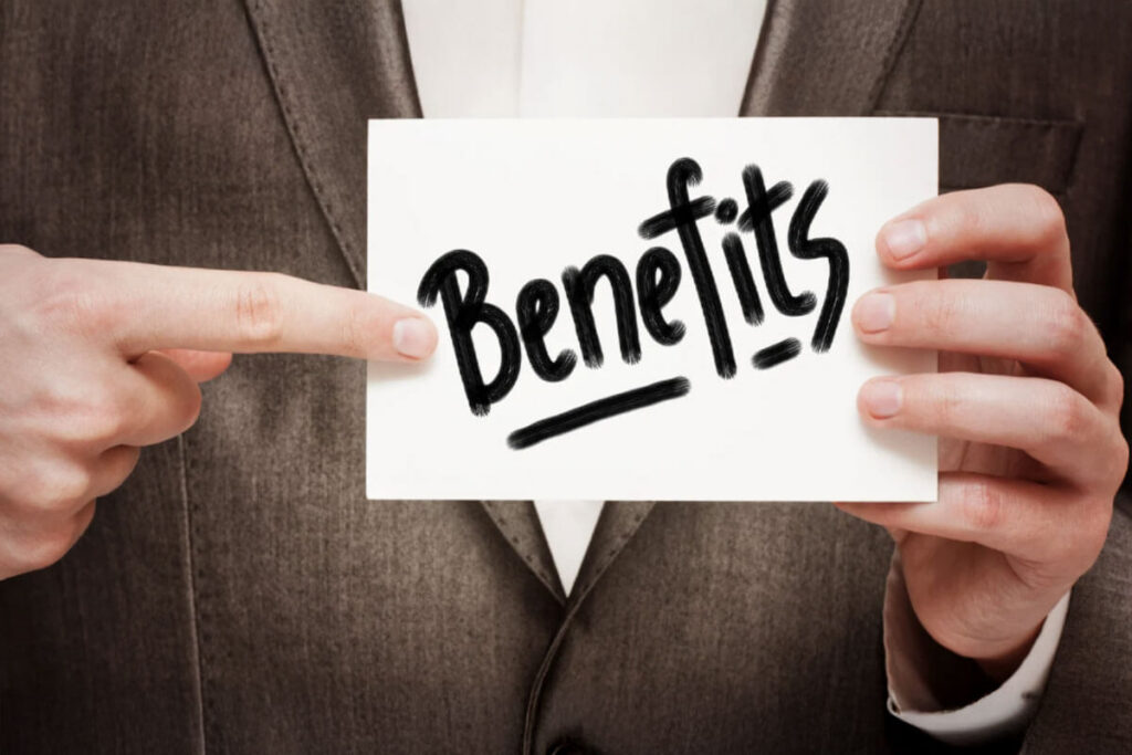 A person in a suit holding a card with the word “Benefits” written on it, highlighting advantages of treatment.